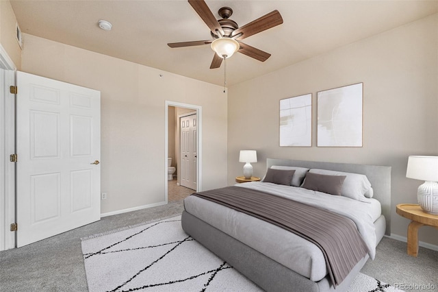 carpeted bedroom featuring ceiling fan and ensuite bathroom