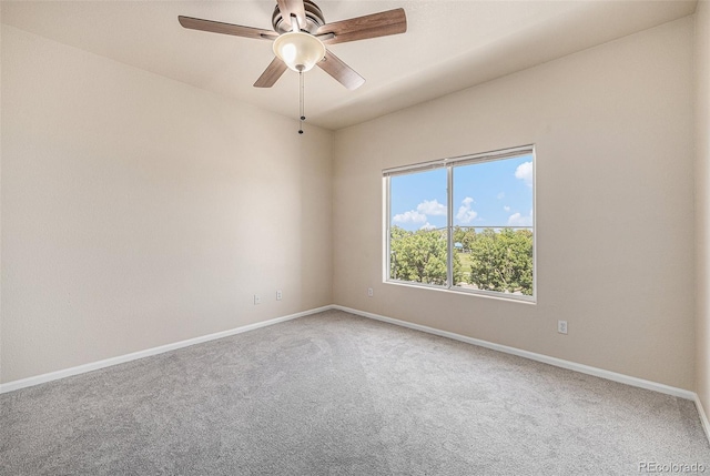 carpeted spare room with ceiling fan