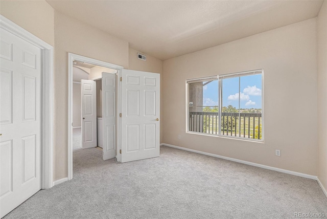 unfurnished bedroom with light carpet