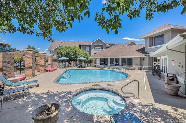 view of swimming pool featuring a patio area and a community hot tub