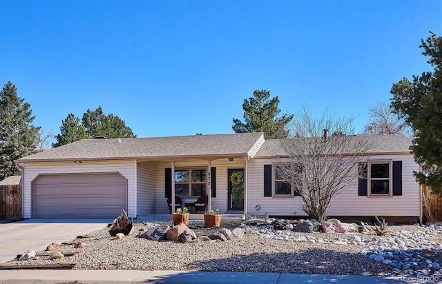 ranch-style house with a garage, covered porch, and concrete driveway