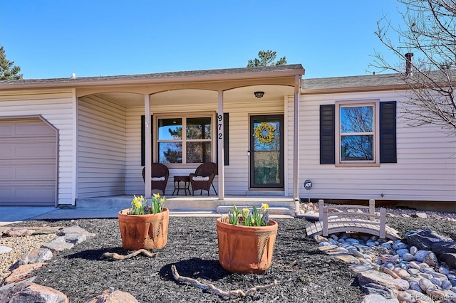 property entrance with a garage and a porch