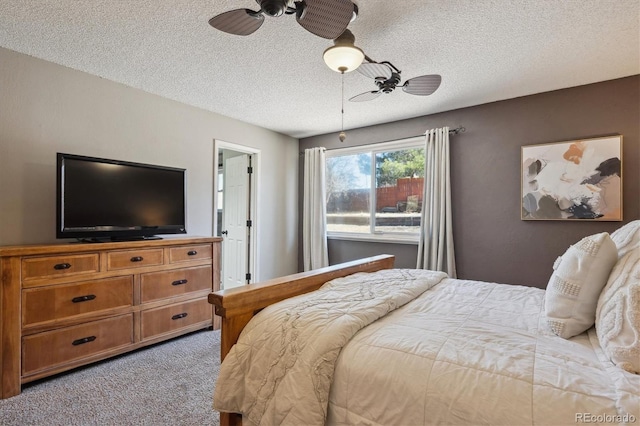 carpeted bedroom with ceiling fan and a textured ceiling