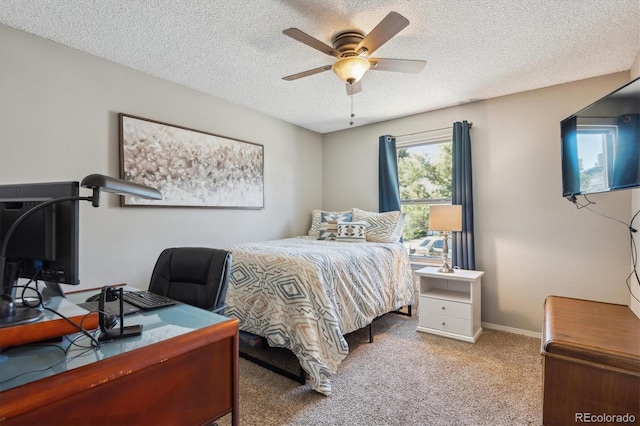 carpeted bedroom featuring ceiling fan, a textured ceiling, and baseboards