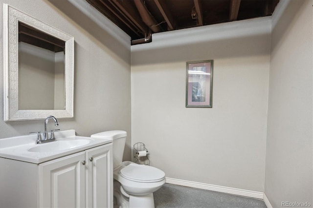 bathroom with toilet, baseboards, and vanity