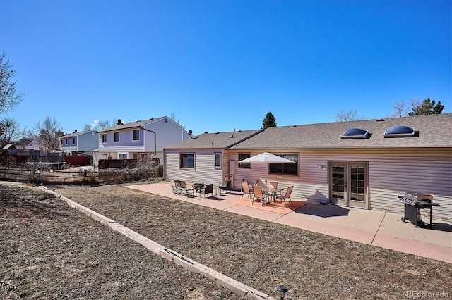 back of house with fence, french doors, and a patio