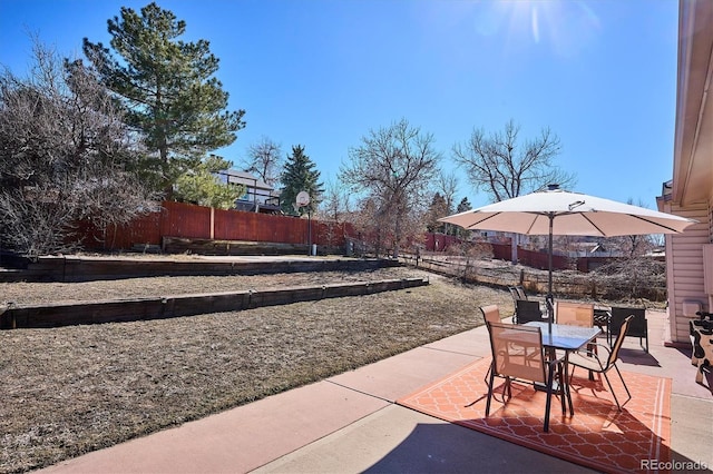 view of patio featuring outdoor dining space and fence