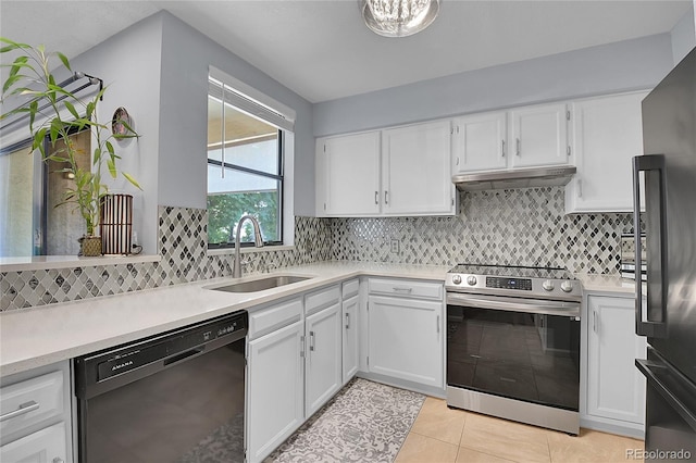 kitchen featuring white cabinetry, light tile patterned flooring, sink, appliances with stainless steel finishes, and backsplash