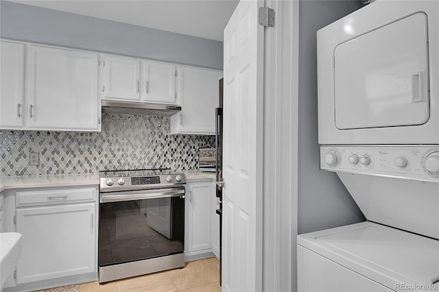 interior space with white cabinetry, light tile patterned flooring, decorative backsplash, stacked washer and dryer, and stainless steel range with electric stovetop