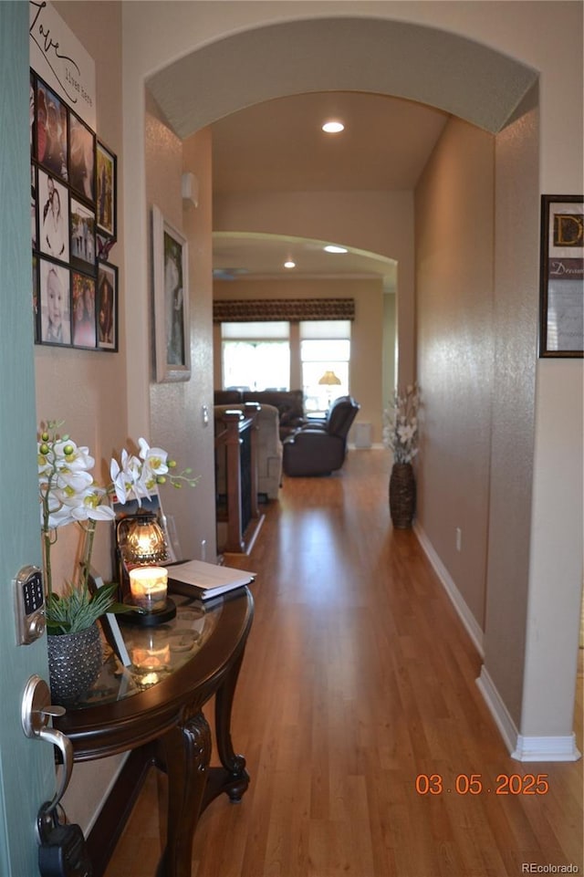 7851 E 148th Dr, Thornton, CO 80602 - hall with arched walkways, baseboards, recessed lighting, and wood finished floors
