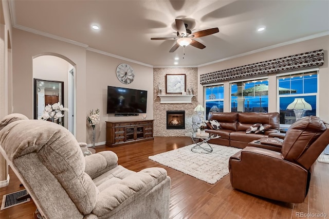 7851 E 148th Dr, Thornton, CO 80602 - living area with visible vents, arched walkways, a ceiling fan, and wood finished floors