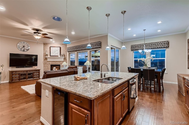 7851 E 148th Dr, Thornton, CO 80602 - kitchen featuring brown cabinets, a sink, ceiling fan with notable chandelier, recessed lighting, and wine cooler