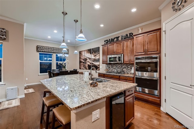 7851 E 148th Dr, Thornton, CO 80602 - kitchen featuring decorative backsplash, a breakfast bar area, light stone countertops, a sink, and stainless steel appliances