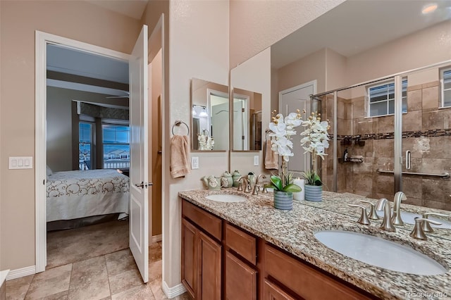 7851 E 148th Dr, Thornton, CO 80602 - full bathroom featuring baseboards, a sink, ensuite bathroom, and a shower stall