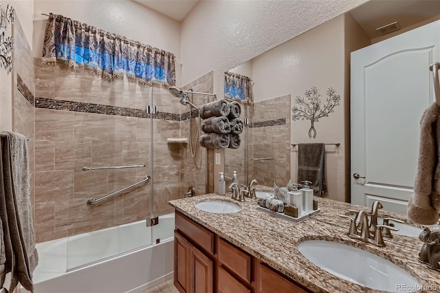 7851 E 148th Dr, Thornton, CO 80602 - full bath with visible vents, a sink, a textured wall, and enclosed tub / shower combo