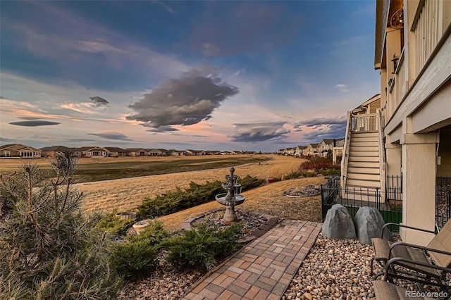 7851 E 148th Dr, Thornton, CO 80602 - patio terrace at dusk featuring fence and stairs