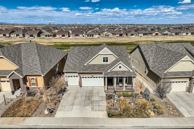 7851 E 148th Dr, Thornton, CO 80602 - view of front of house featuring a garage, covered porch, a residential view, and concrete driveway