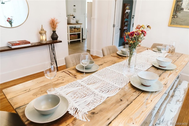 dining room with baseboards and wood finished floors