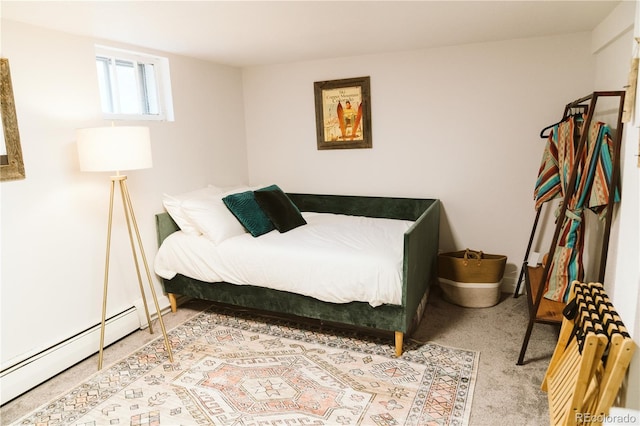 carpeted bedroom with a baseboard heating unit