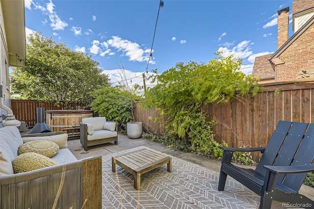 view of patio / terrace with an outdoor living space and a fenced backyard