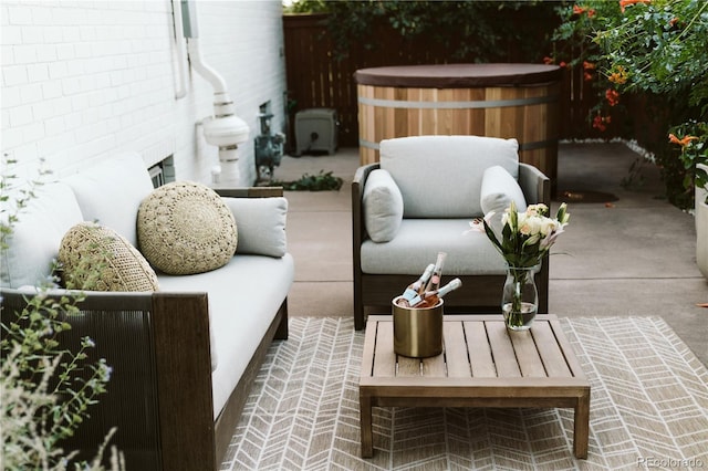 view of patio featuring a hot tub and fence