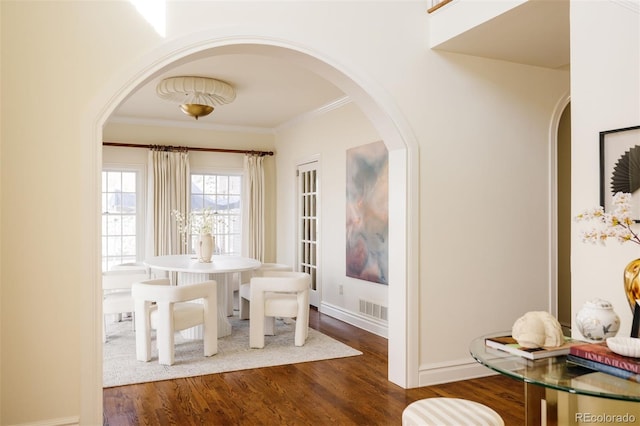 5700 S Steele St, Greenwood Village, CO 80121 - dining room with arched walkways, wood finished floors, and ornamental molding