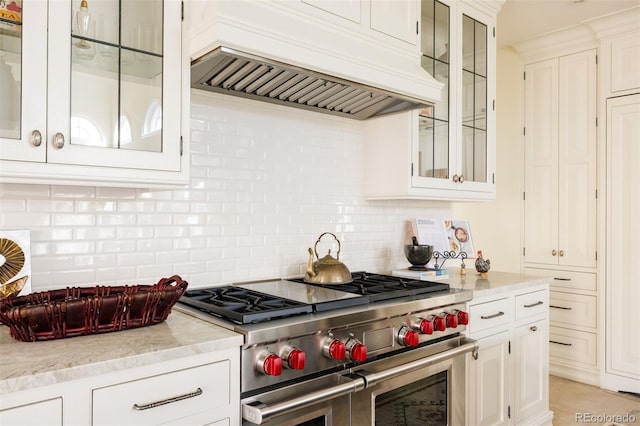 5700 S Steele St, Greenwood Village, CO 80121 - kitchen featuring range with two ovens, custom exhaust hood, backsplash, and white cabinetry