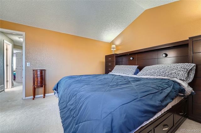 bedroom featuring lofted ceiling, light carpet, baseboards, and a textured ceiling