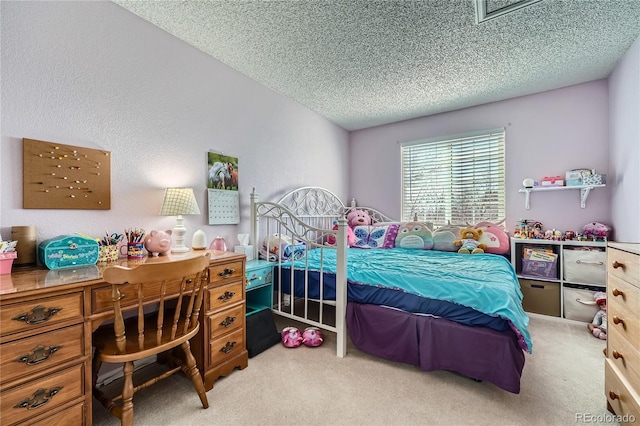 bedroom with a textured ceiling and light colored carpet