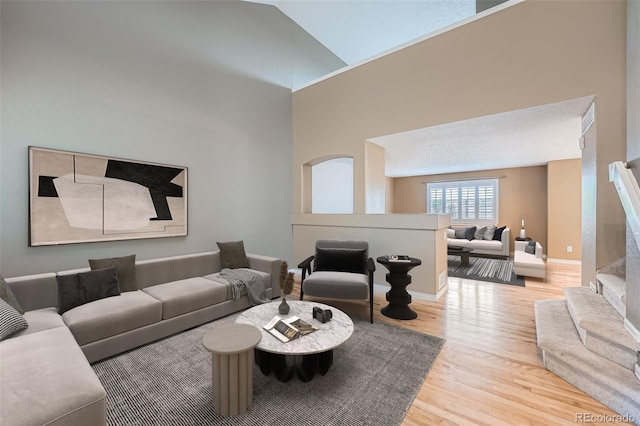 5130 S Wenatchee St, Aurora, CO 80015 - living area featuring wood finished floors, baseboards, and stairway