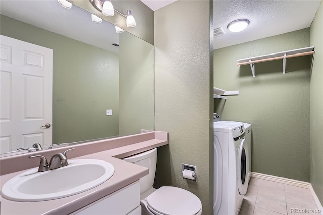 5130 S Wenatchee St, Aurora, CO 80015 - bathroom featuring separate washer and dryer, toilet, tile patterned flooring, vanity, and baseboards
