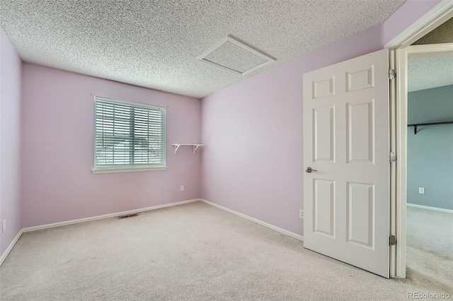 5130 S Wenatchee St, Aurora, CO 80015 - carpeted empty room featuring a textured ceiling, baseboards, and attic access
