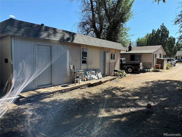 back of property featuring an outdoor structure