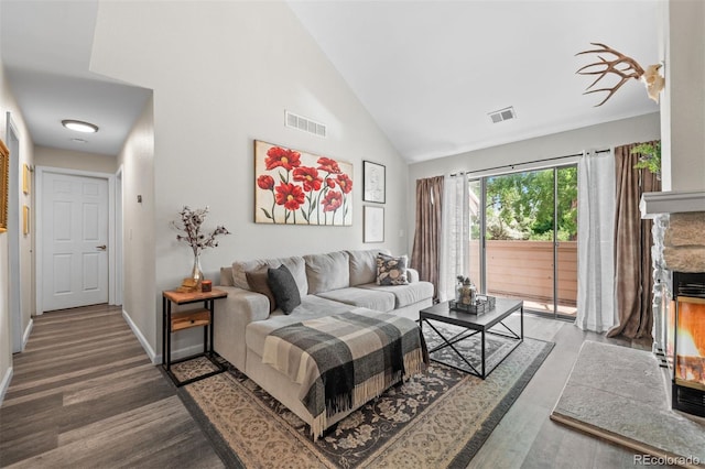 3600 S Pierce St Unit 7-208, Denver, CO 80235 - living room with wood finished floors, high vaulted ceiling, and a fireplace