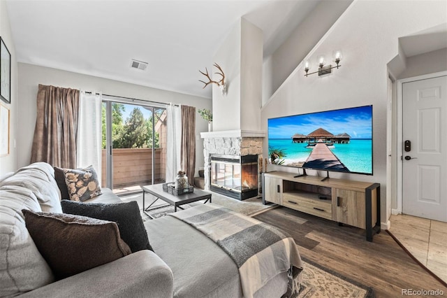 3600 S Pierce St Unit 7-208, Denver, CO 80235 - living room featuring wood finished floors and a stone fireplace