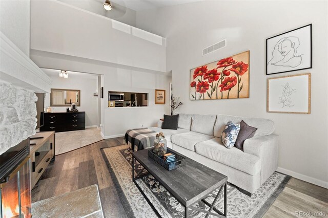 3600 S Pierce St Unit 7-208, Denver, CO 80235 - living room with wood finished floors and a high ceiling