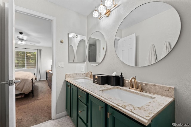 3600 S Pierce St Unit 7-208, Denver, CO 80235 - bathroom with connected bathroom, double vanity, and a ceiling fan