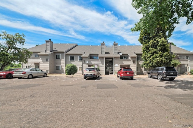 3600 S Pierce St Unit 7-208, Denver, CO 80235 - view of property with uncovered parking and a residential view