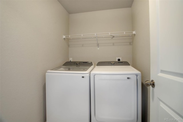 washroom featuring washer and clothes dryer