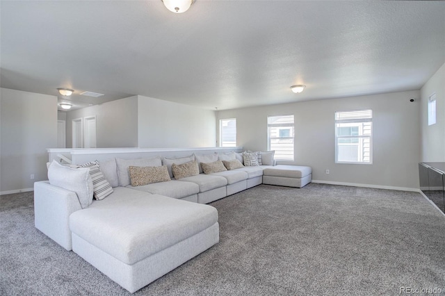 carpeted living room featuring a textured ceiling