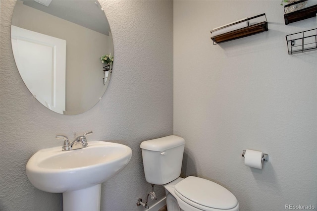 bathroom with toilet and sink