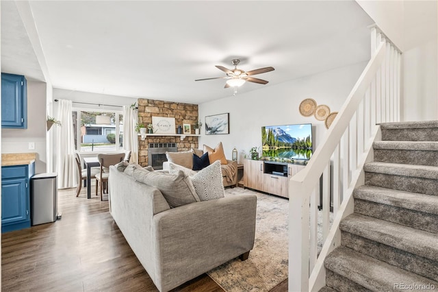 1080 S Yampa St, Aurora, CO 80017 - living area with stairs, a ceiling fan, wood finished floors, and a fireplace