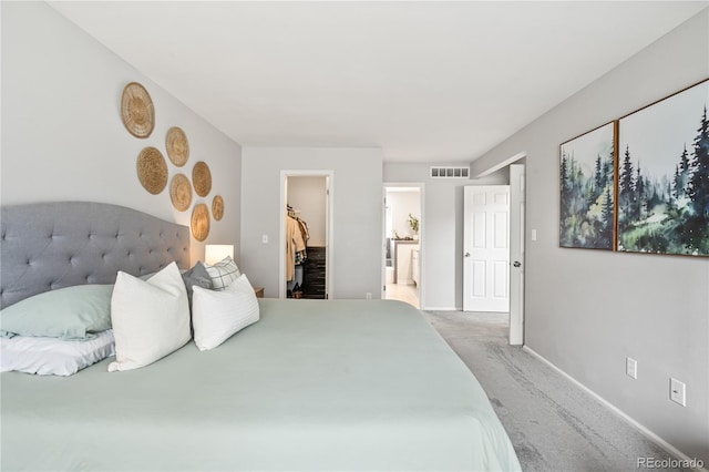 1080 S Yampa St, Aurora, CO 80017 - carpeted bedroom with a walk in closet, baseboards, ensuite bath, and a closet
