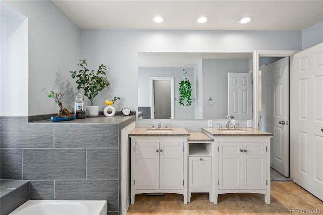 1080 S Yampa St, Aurora, CO 80017 - bathroom with double vanity, a garden tub, and recessed lighting