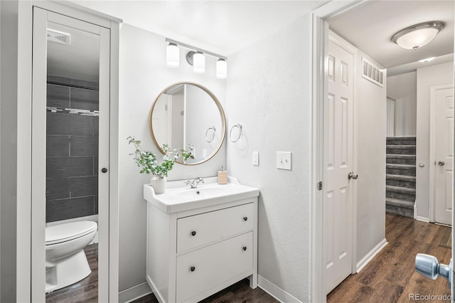 1080 S Yampa St, Aurora, CO 80017 - bathroom featuring wood finished floors, toilet, vanity, baseboards, and a shower