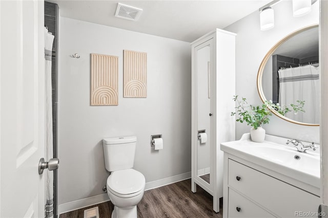 1080 S Yampa St, Aurora, CO 80017 - full bathroom with wood finished floors, vanity, toilet, and baseboards