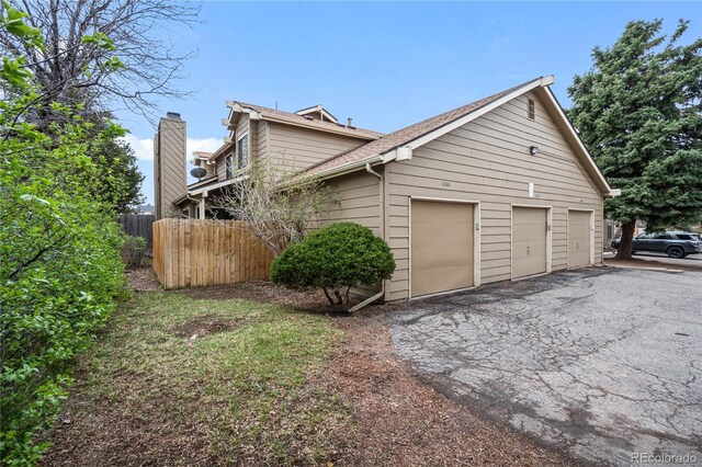 1080 S Yampa St, Aurora, CO 80017 - view of property exterior with driveway, roof with shingles, and an attached garage