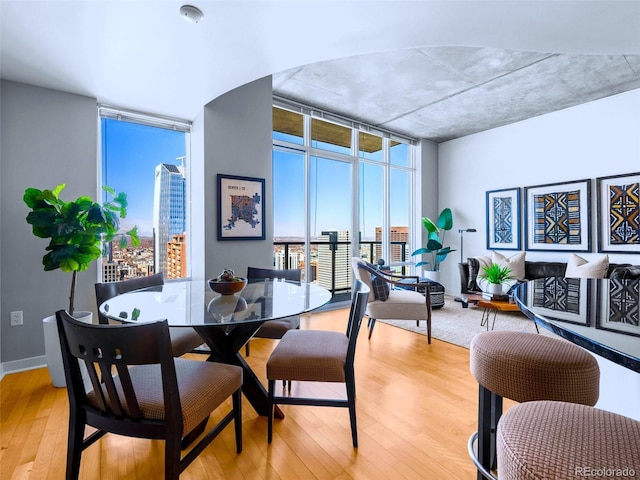 dining room featuring light hardwood / wood-style flooring and expansive windows