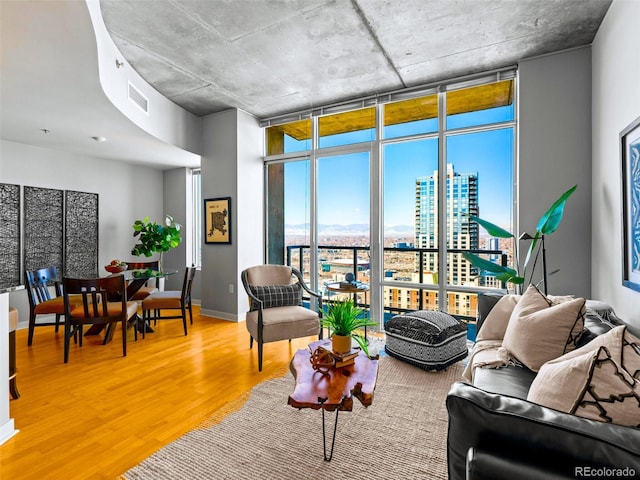 living room with expansive windows and hardwood / wood-style flooring