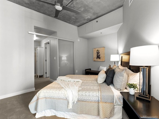 carpeted bedroom with ceiling fan and a closet